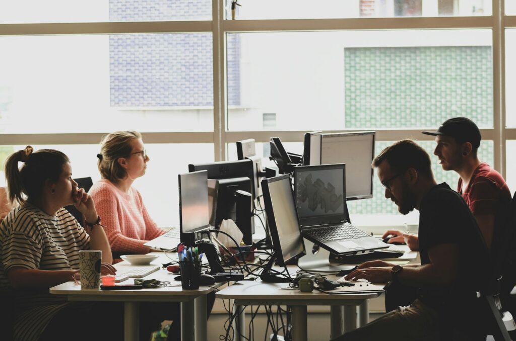A diverse product team works at computers