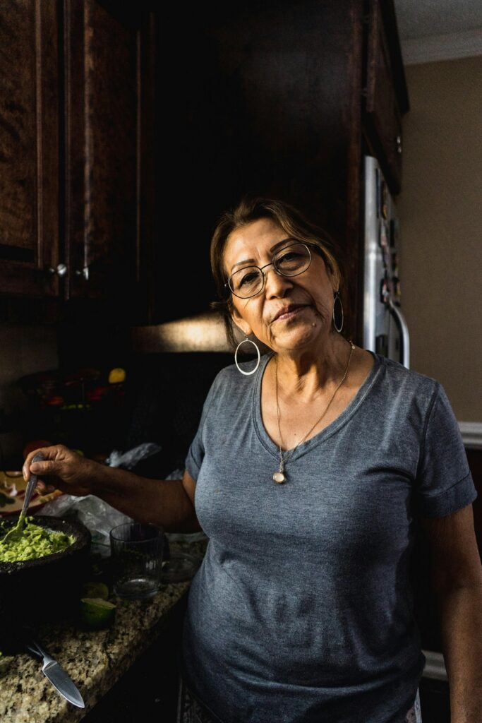 An older Latina woman smiles at home