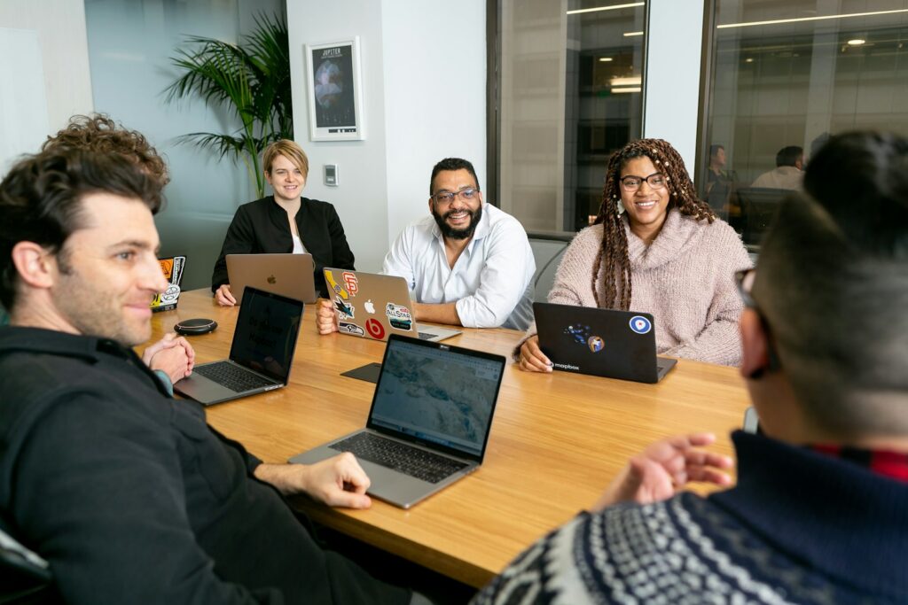 A diverse team meets around a table