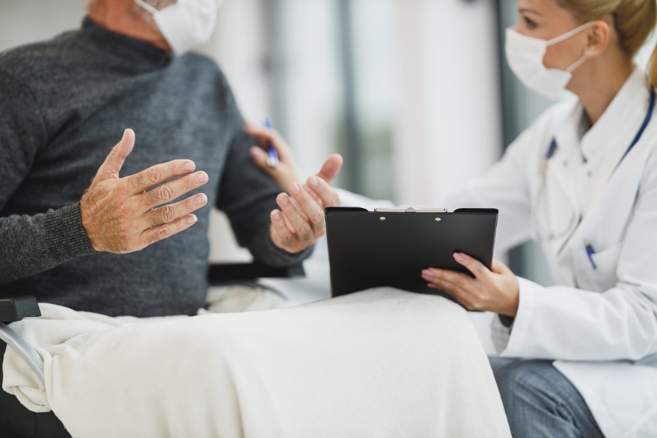 Clinician explaining a consent form to a patient