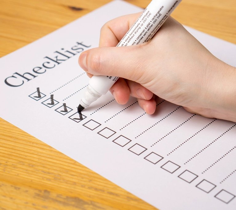 A language access coordinator checks items off a compliance checklist