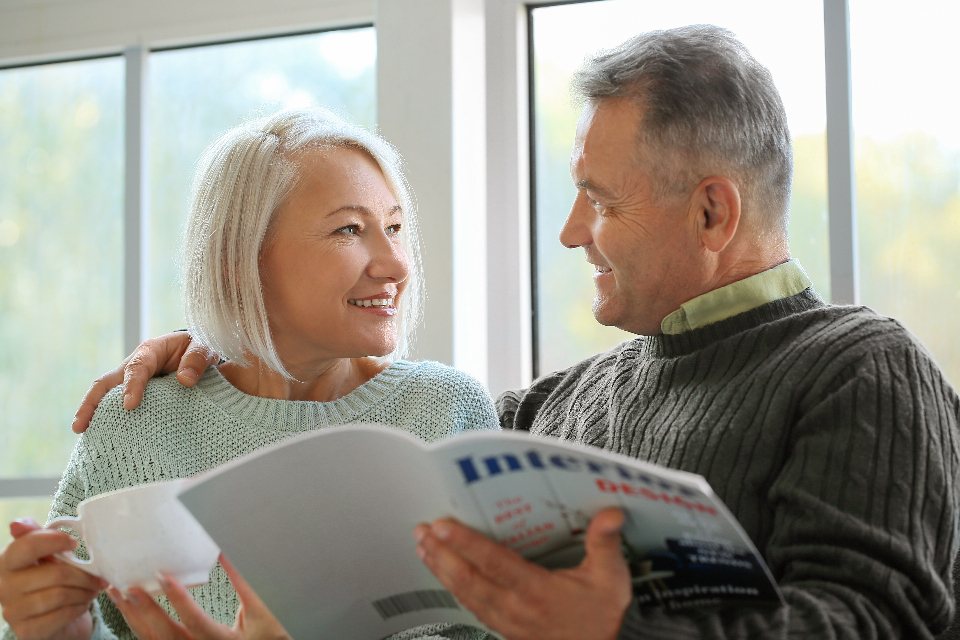 Older couple reading a printed brochure together