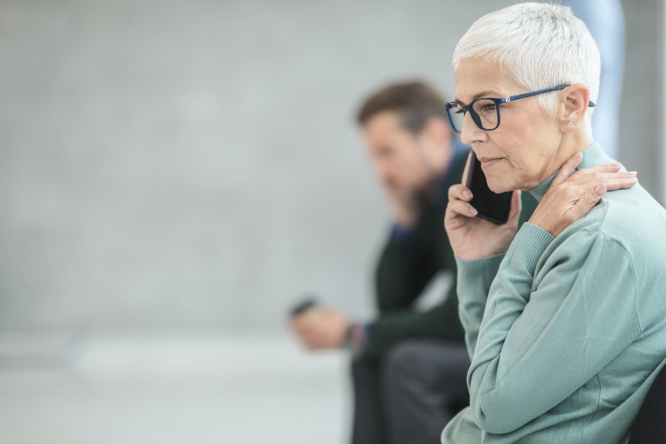 Older woman speaking on the phone with a remote interpreter